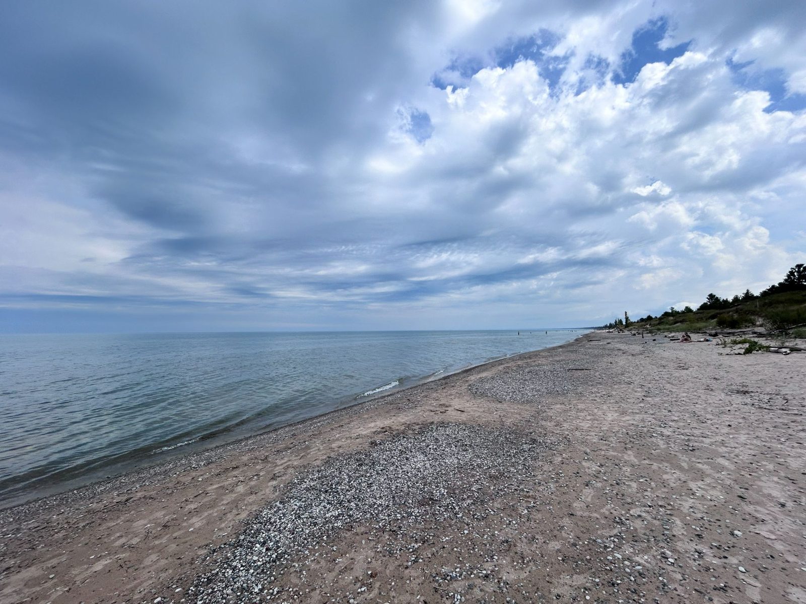 Cloud building over a calm Lake Huron and an almost empty Pinery beach on the morning of departure